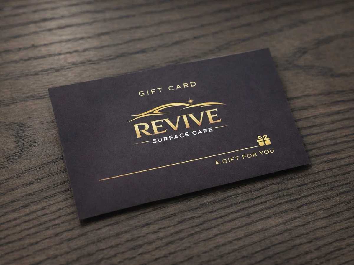 Revive Surface Care gift card on a wooden table